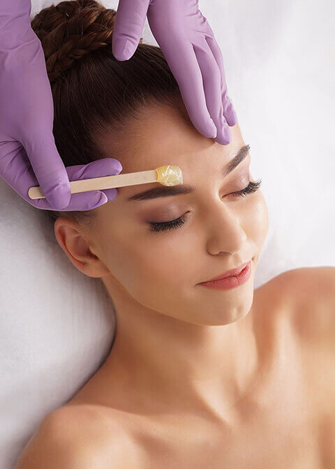 Client receiving a professional facial waxing service